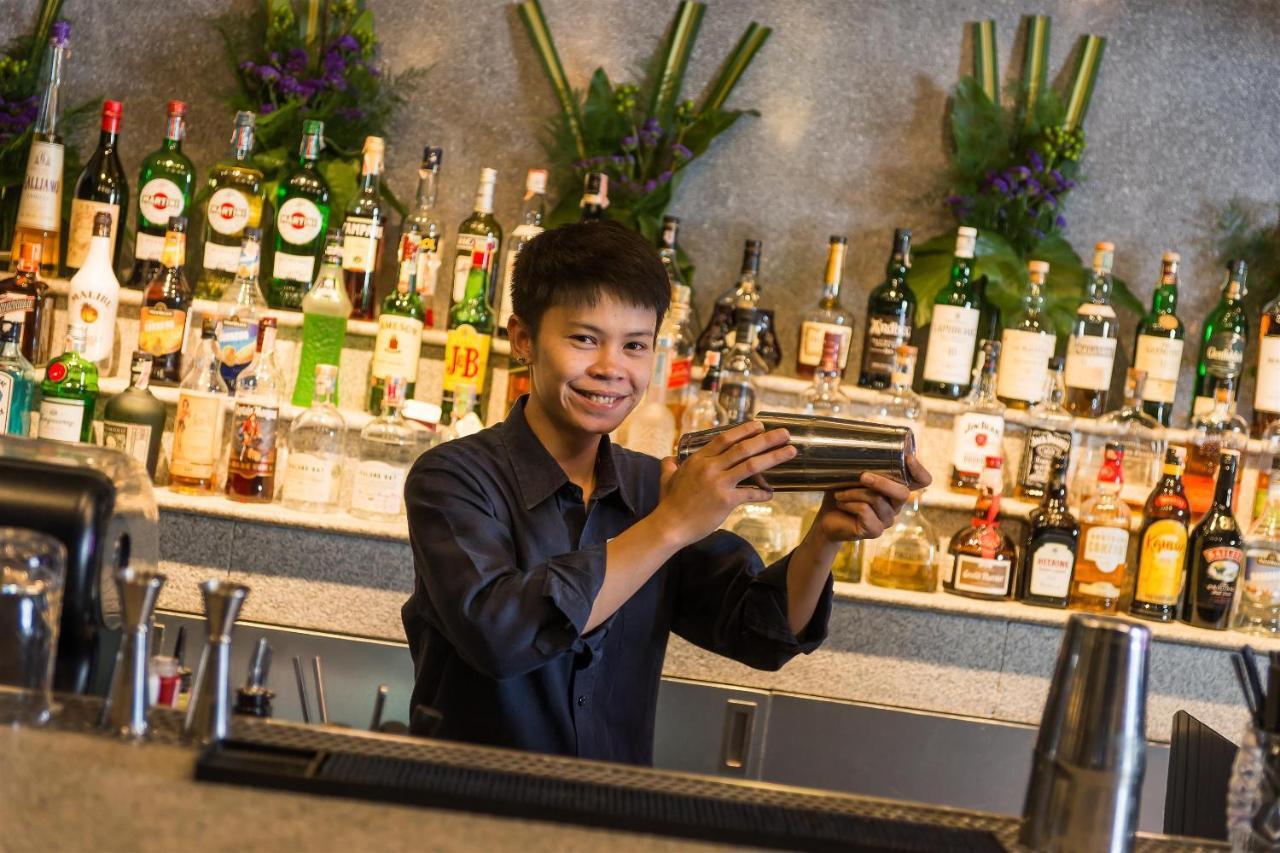 Akara Hotel Bangkok Exteriör bild A bartender shaking a cocktail